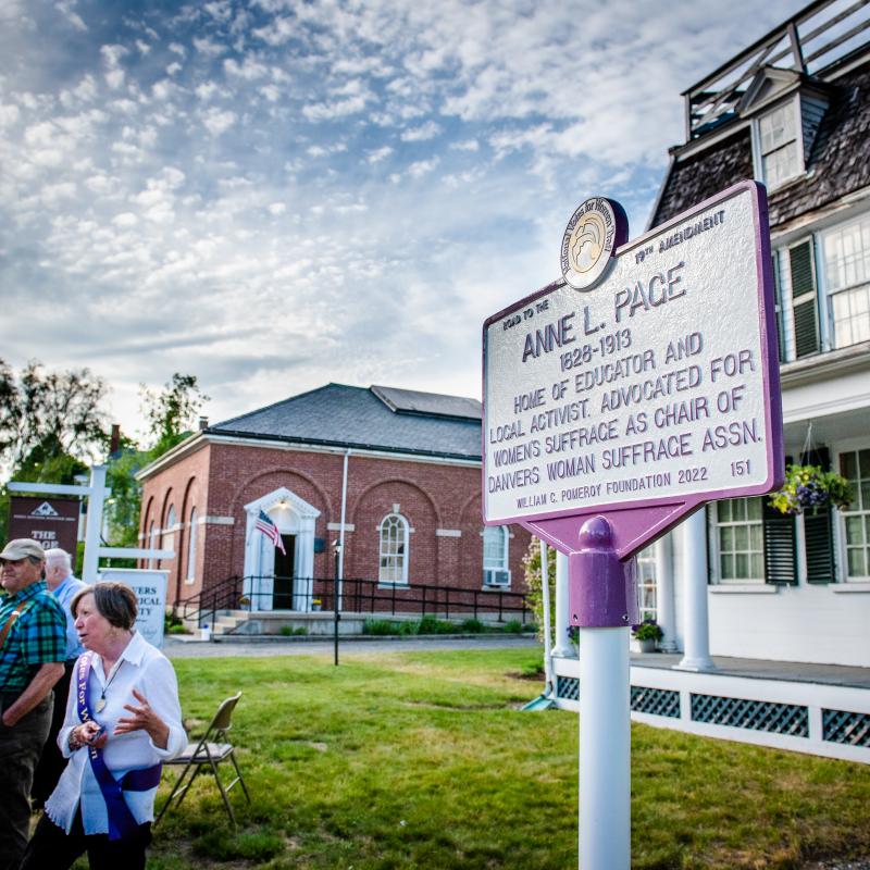 Purple and white sign for Anne L. Page.