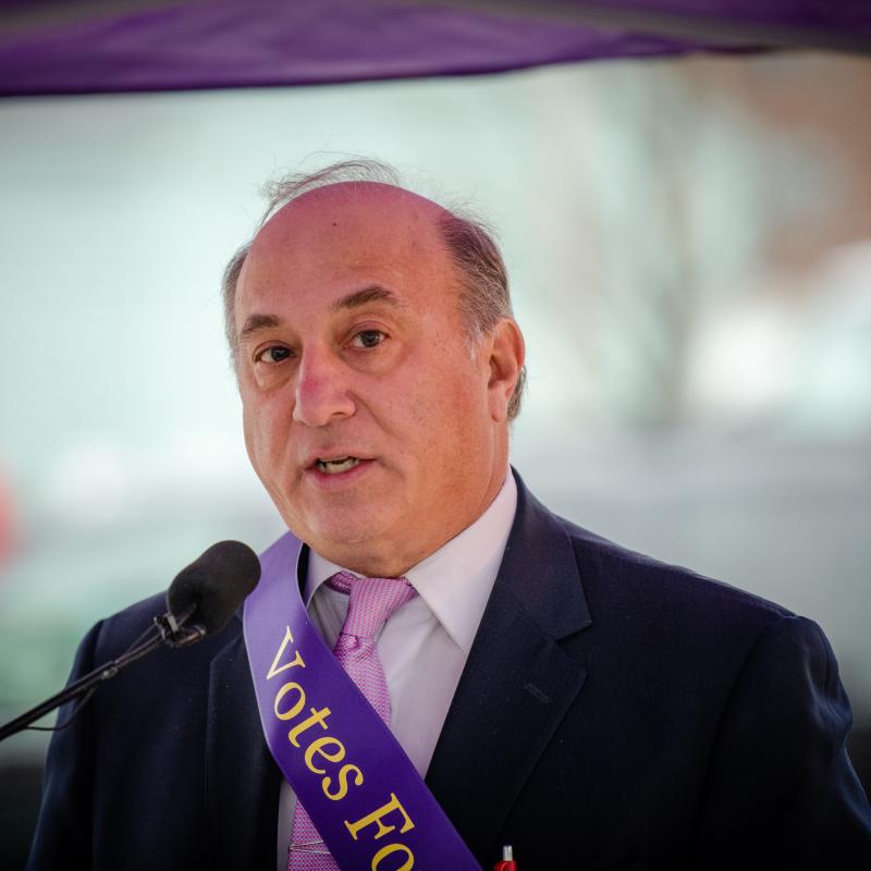 Man stands at podium speaking.