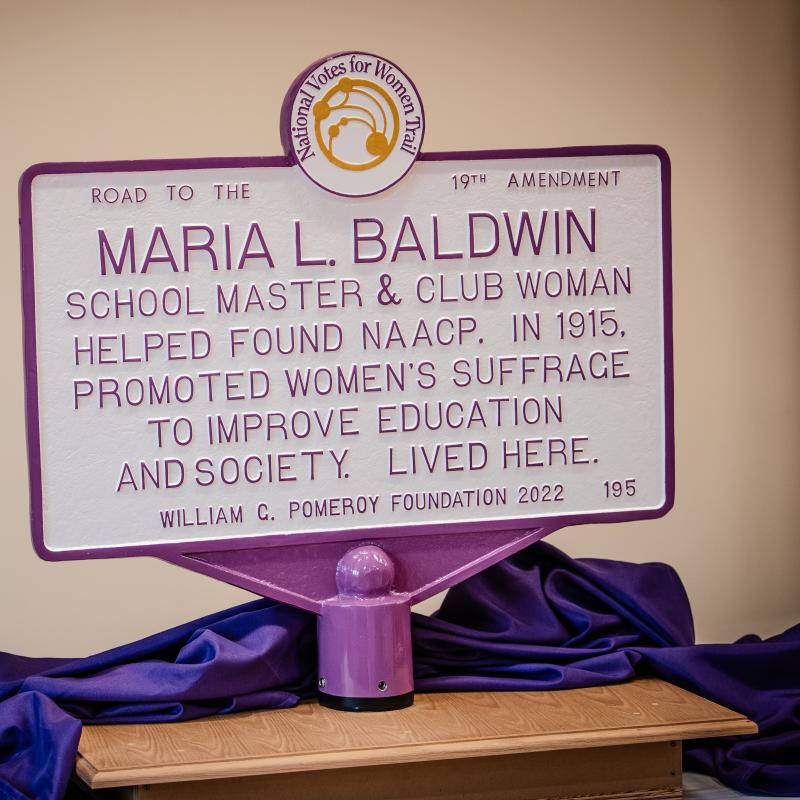 Purple and white sign for Maria L. Baldwin.