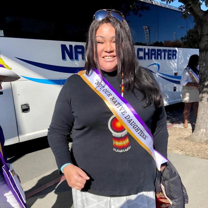 Woman wearing sash.