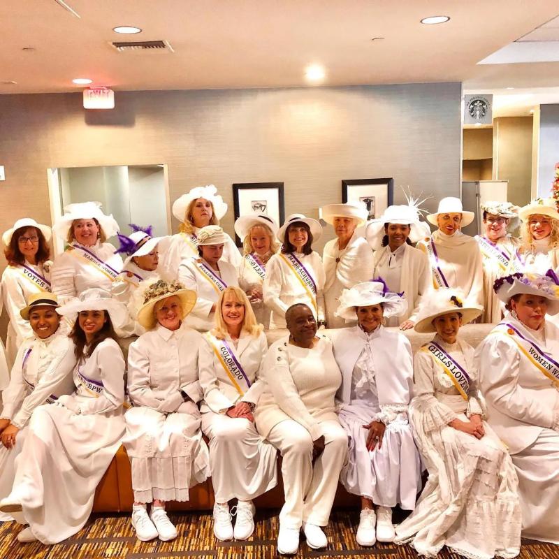 Group of women wearing white.