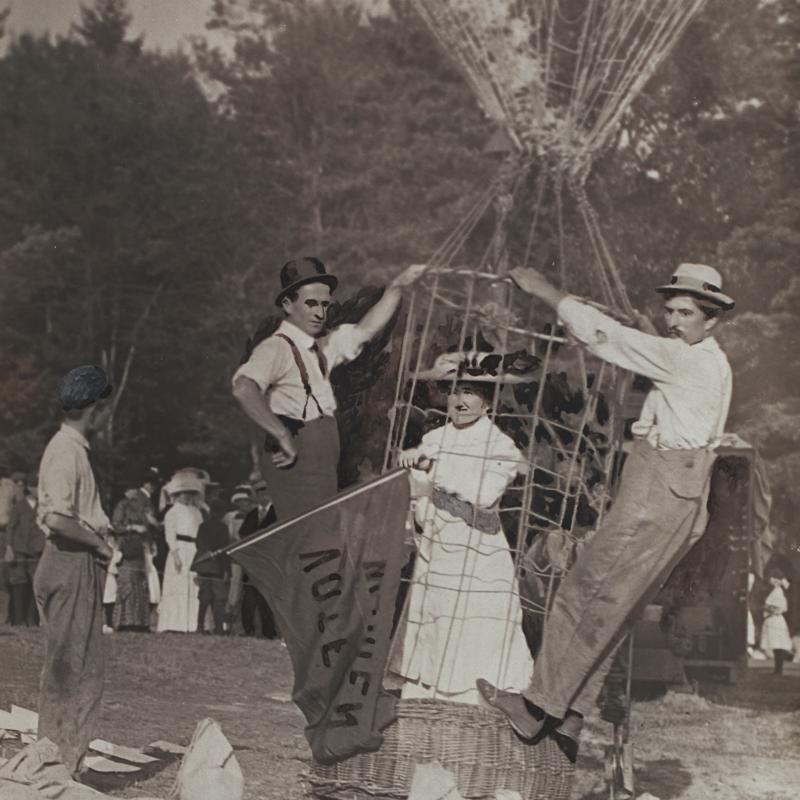Margaret Foley in hot air balloon accompanied by three men with onlookers