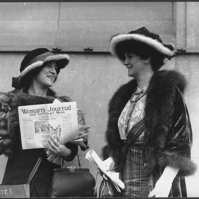 Black and white photograph of Foley and another woman selling The Woman's Journal newspaper