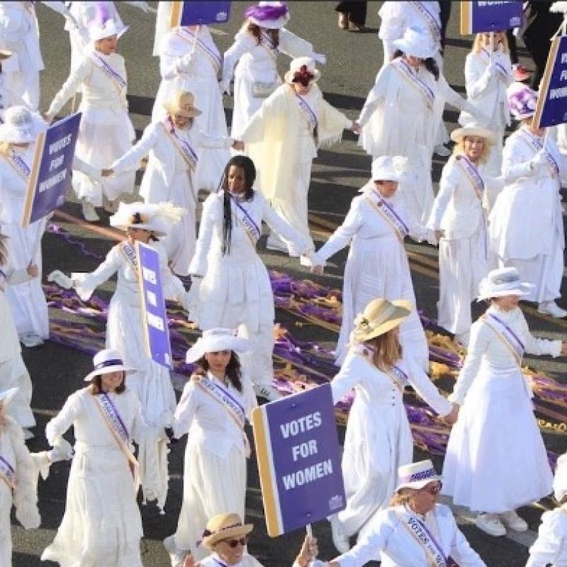 Crowd of women wearing white walking together.