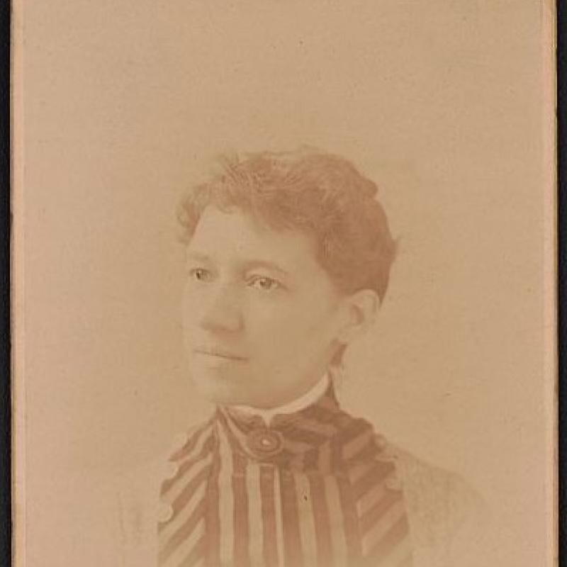 Vintage sepia-toned portrait of a young woman in striped attire on an Elmer Chickering photography studio card from Boston, 1885..