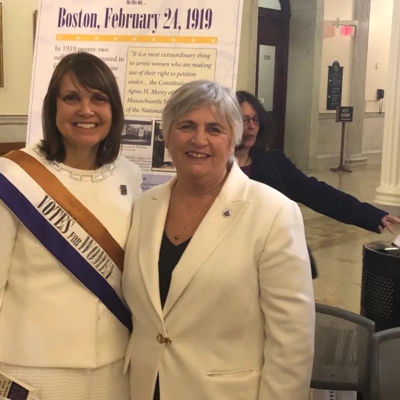 Two women smile at camera.