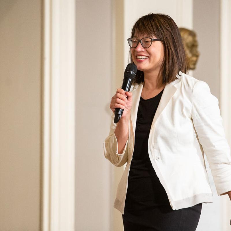 Woman speaks into microphone.