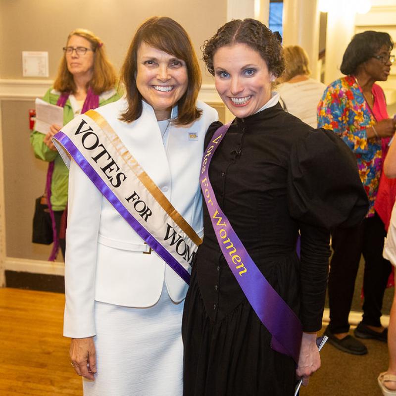 Two women smile at camera.