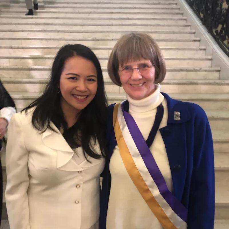 Two women smile at camera.