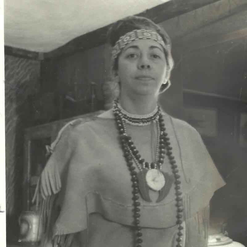 Black and white photo of woman in Native dress.