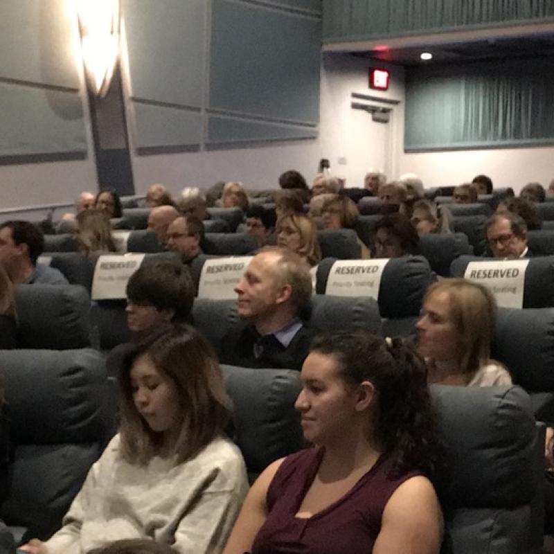 Audience seated in movie theater.