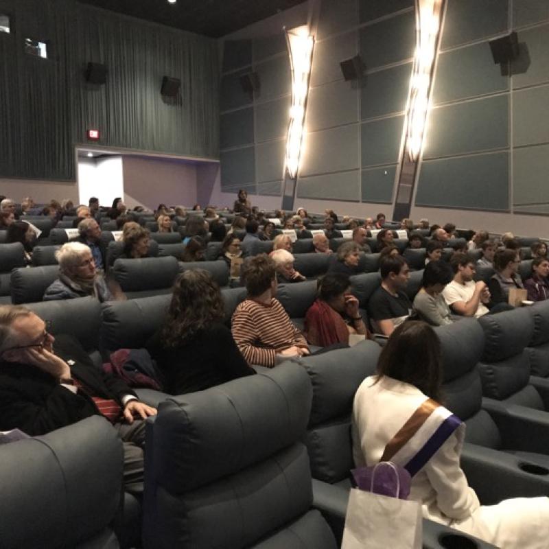 Audience seated in movie theater.