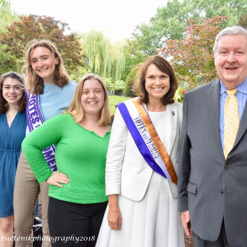 Six people stand outside smiling.