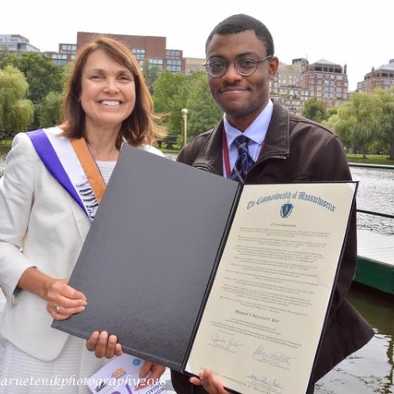 Two adults hold certificate.