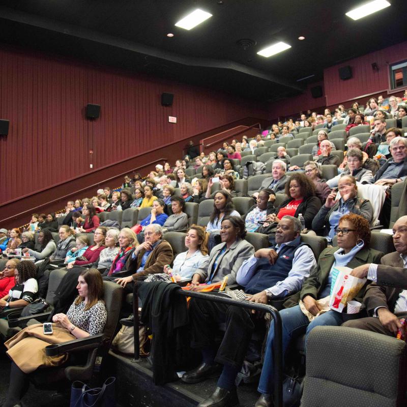 Audience seated in movie theater.