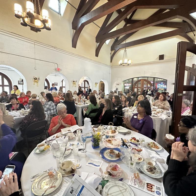 Wide shot of room with tables and guests.