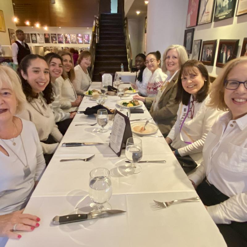 A group of people sitting at a table at a restaurant