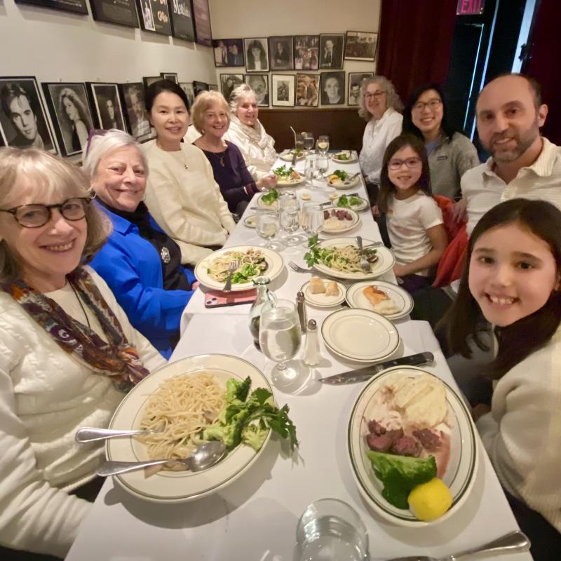 A group of people sitting at a table at a restaurant