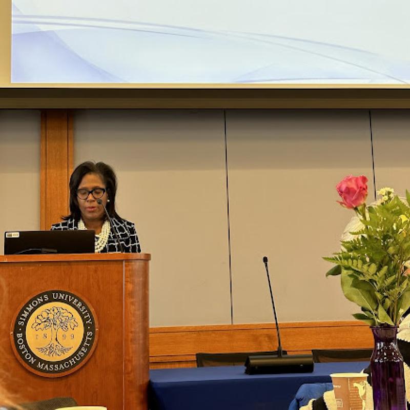 Woman speaking at podium.