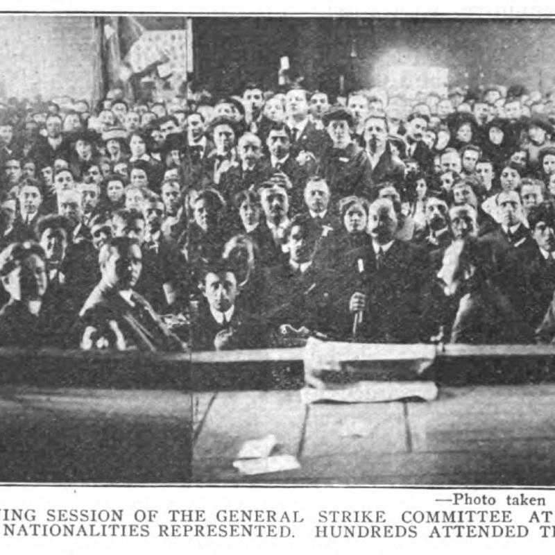 Black and white photo of crowd gathered indoors.