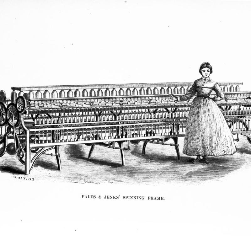 woman standing next to a pice of factory machinery