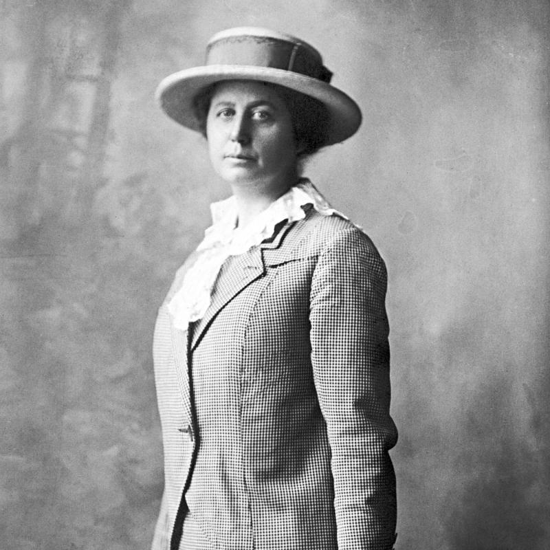 Black and white photo of woman wearing hat.