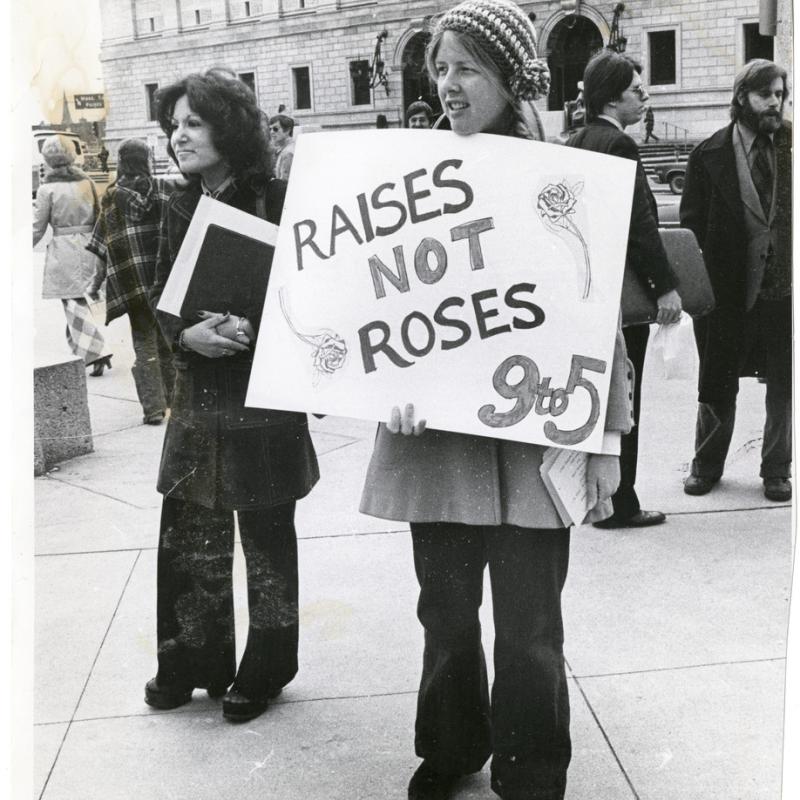 women at a protest outside holing signs