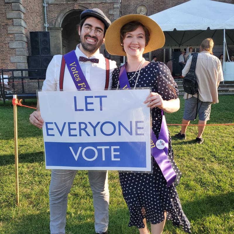 Man and woman hold sign "Let Everyone Vote."