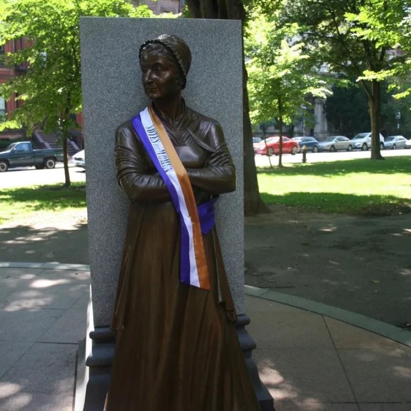 Statue wearing sash.