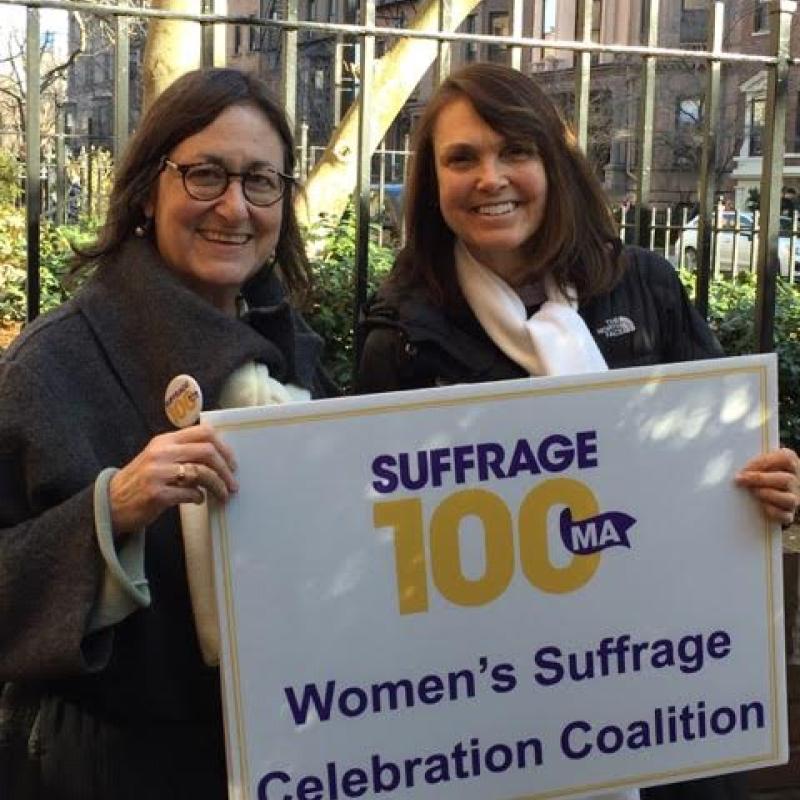 Women hold Suffrage100MA signs.