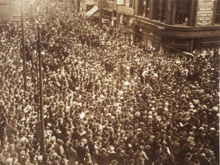 Aerial view of the corner of Washington and School streets, packed tightly with people.