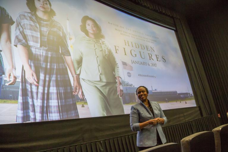 Woman standing in front of a movie screen