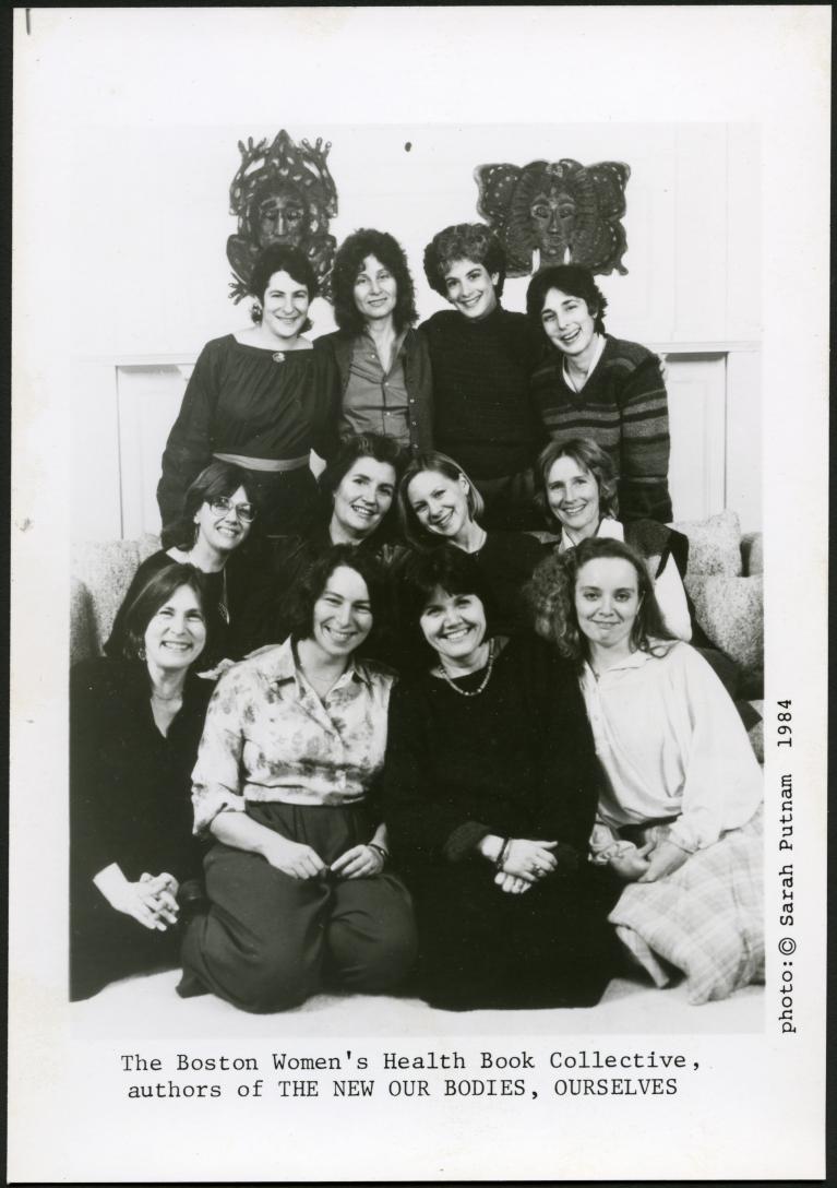 Black and white photograph of 12 women in three rows.