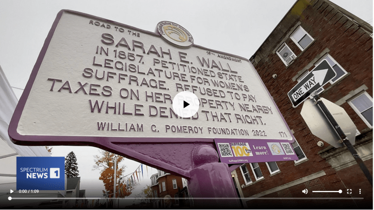 White and purple sign for Sarah E. Wall.