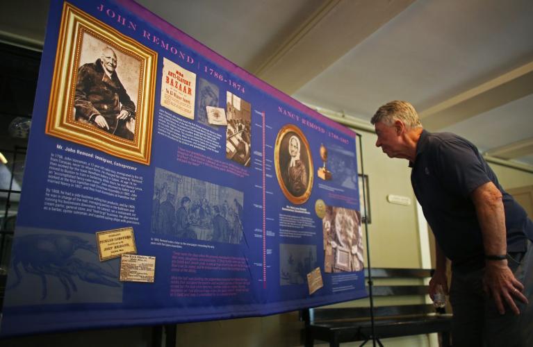 Bill Hayes studies one of five Remond banners inside Hamilton Hall in Salem.