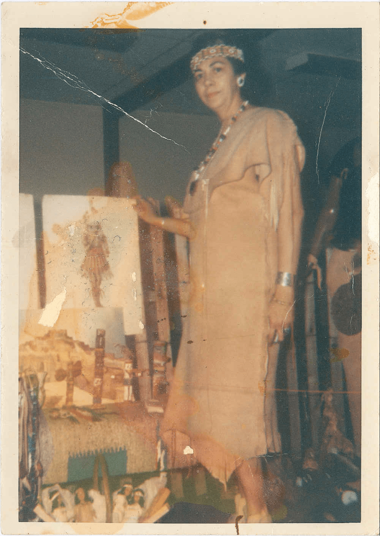 Photo of woman standing wearing Native dress.